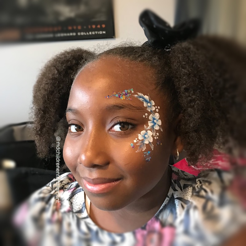 Flower face painting on a beautiful girl! Hire us in Tweed, Belleville, Kingston & surrounding areas.